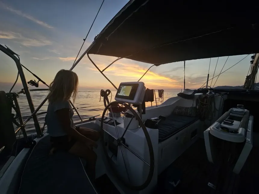 Sailboat cockpit at sunset on a calm sea — Nerida, Atlantic sail-training cruises